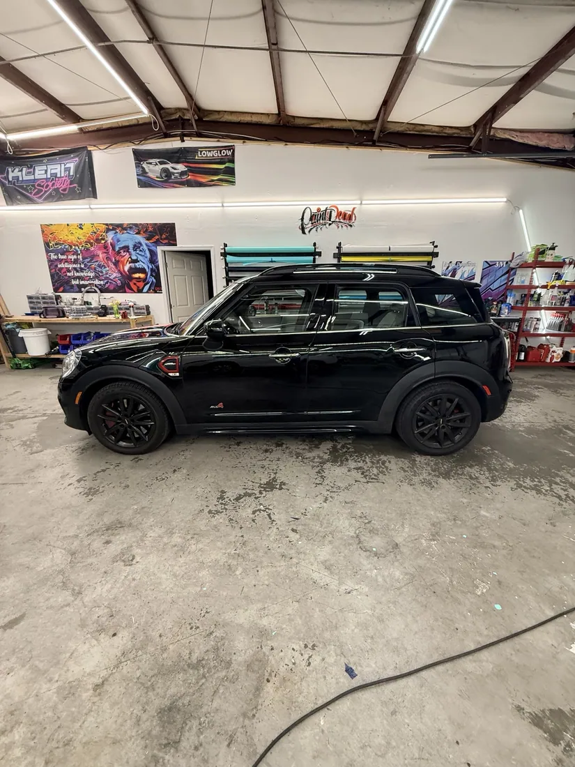 An actual GNS Designs work bay filled with vehicle wrap projects