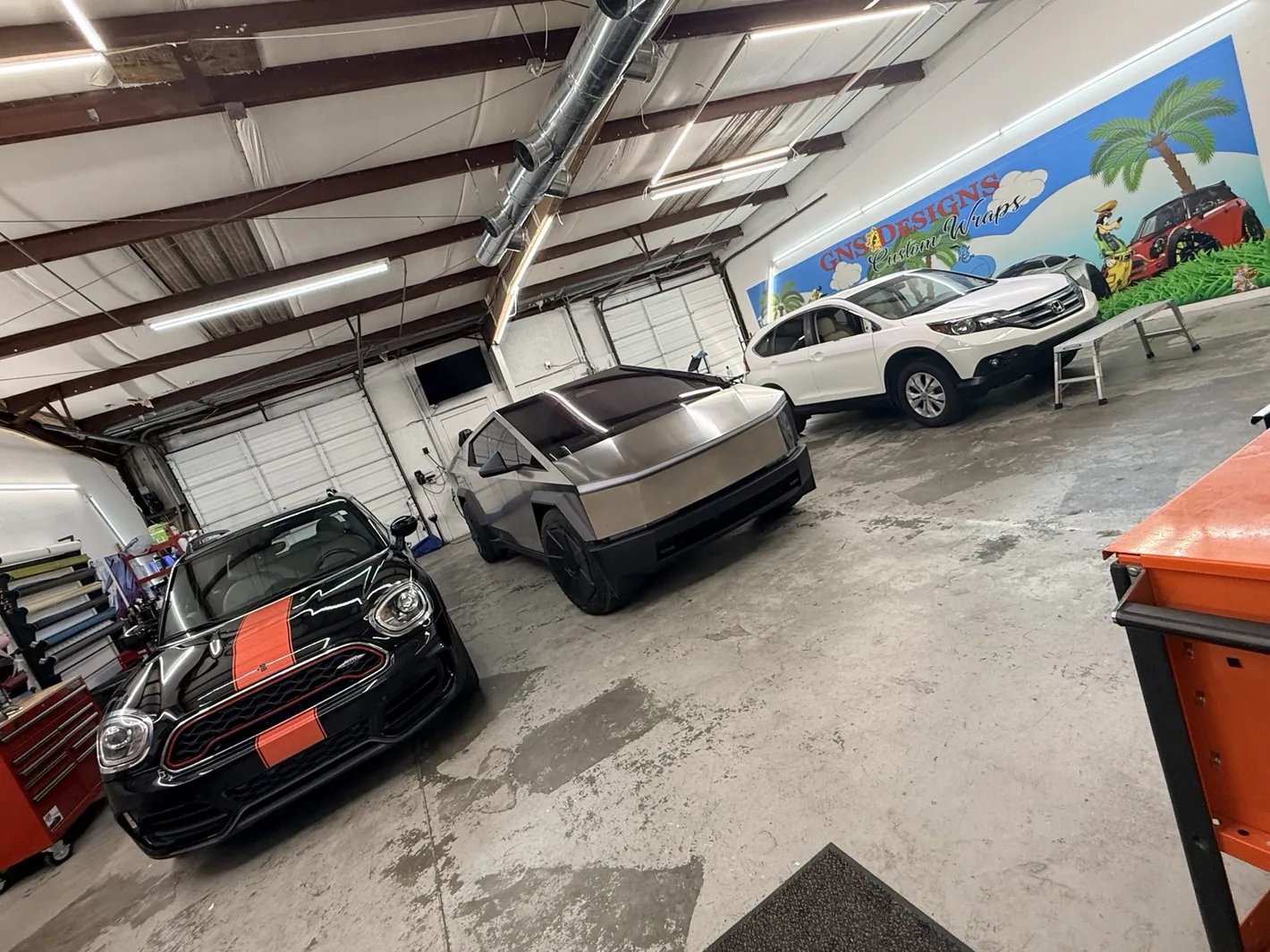 Actual GNS Designs installation shop interior with several vehicles